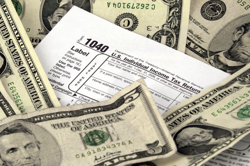 1040 Tax form surrounded by dollar bills