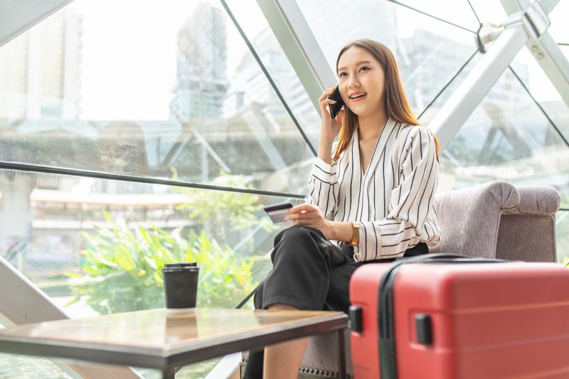 Portrait photo of a young business woman smiling while on the phone