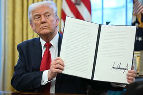 President Donald Trump holding an executive order he signed announcing tariffs on auto imports on March 26, 2025