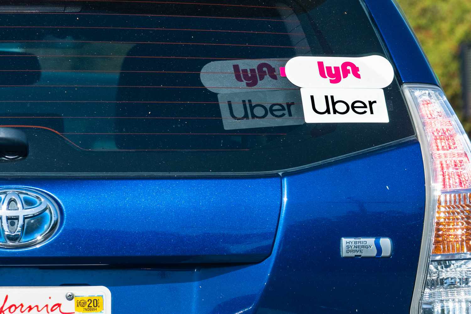 Lyft and Uber stickers seen on a Toyota. 