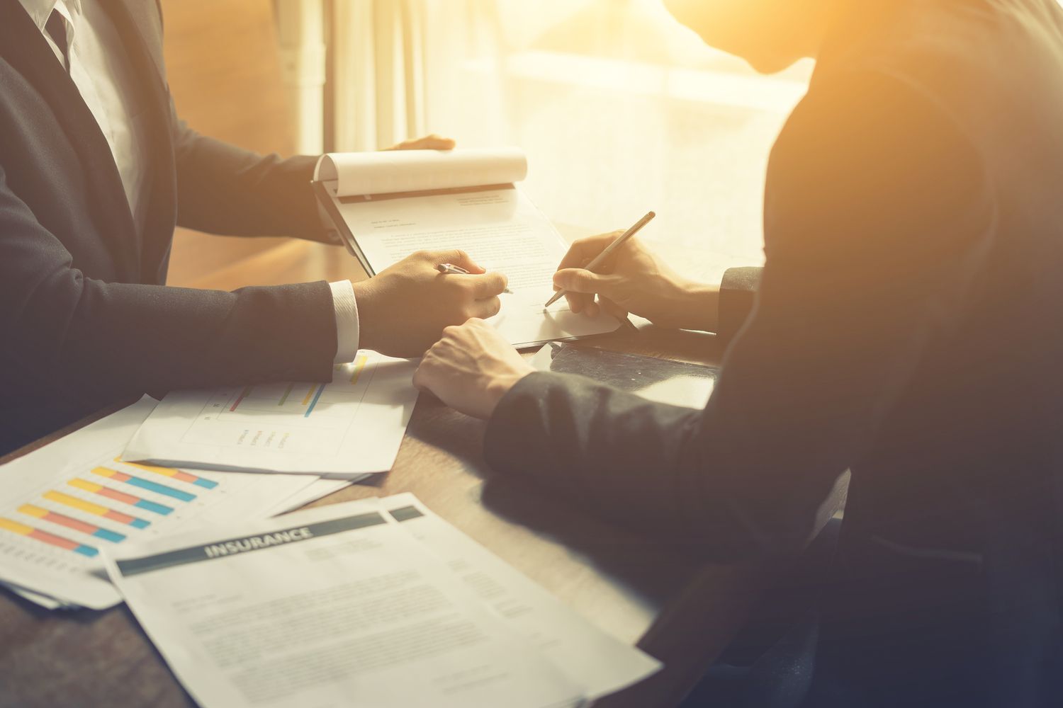 Businessperson Signing Contract about insurance, Two people writing with pen sign of modest agreements form In modern office