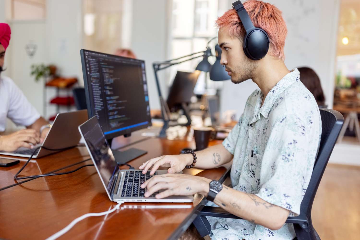 A young man working at a computer.