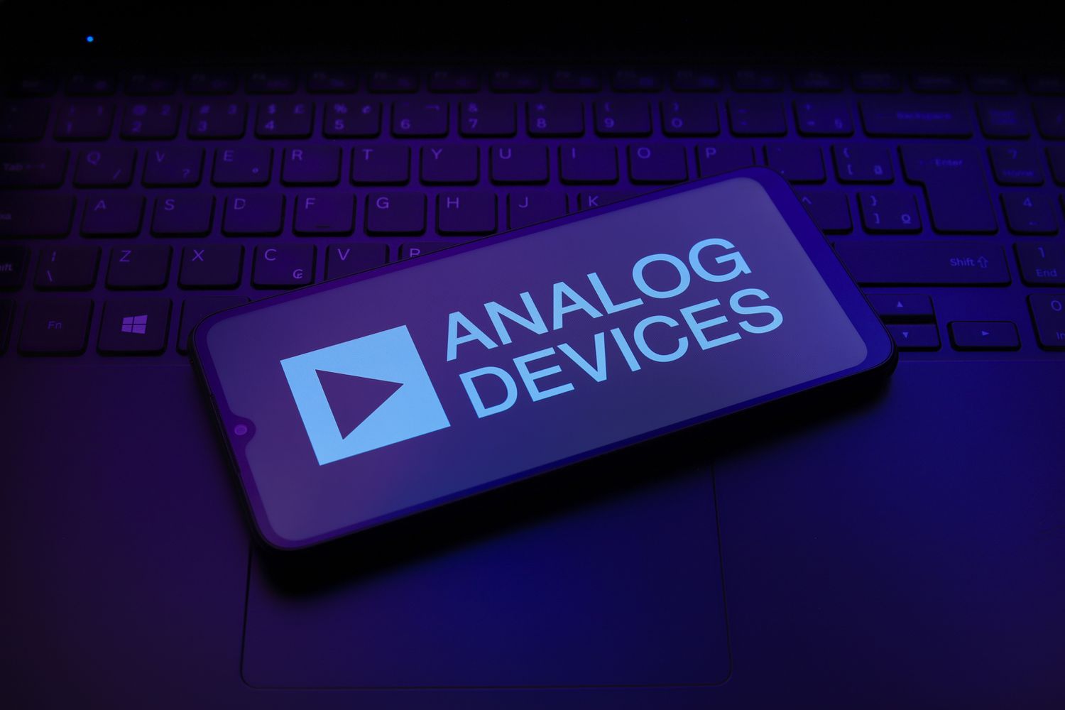 Analog Devices logo on a smartphone screen that sits on a keyboard