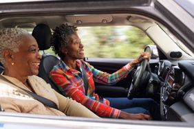 A woman drives a car.