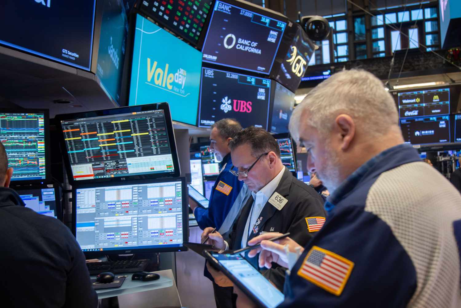 Traders work below Vale SA signage on the floor of the New York Stock Exchange.