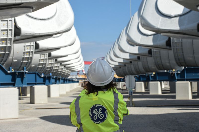 General Electric employee walks between wind turbine nacelles for the construction of a wind farm off