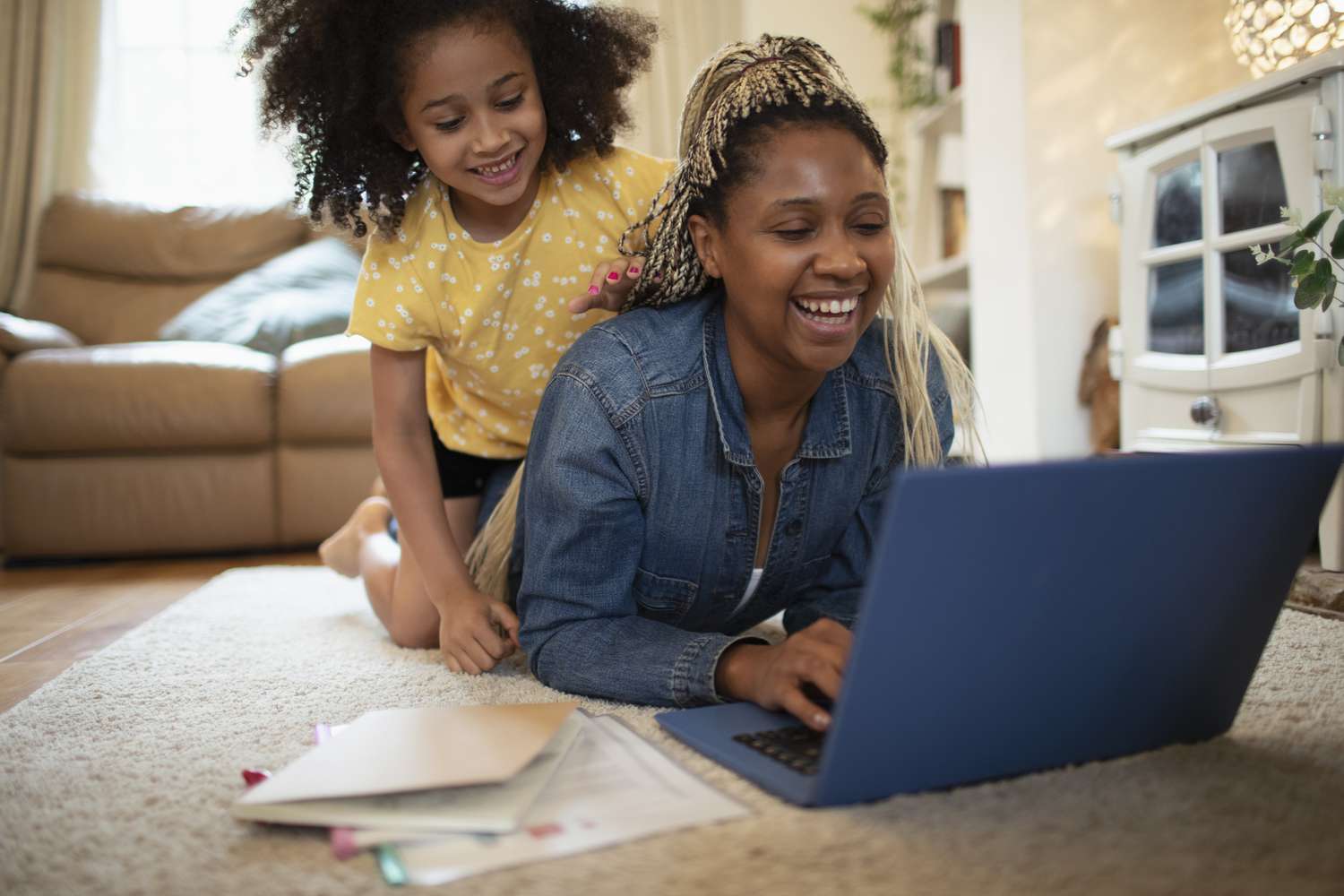 Mother and daughter with laptop in a living room