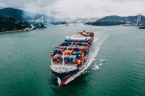 Fully loaded container ship sailing in the ocean
