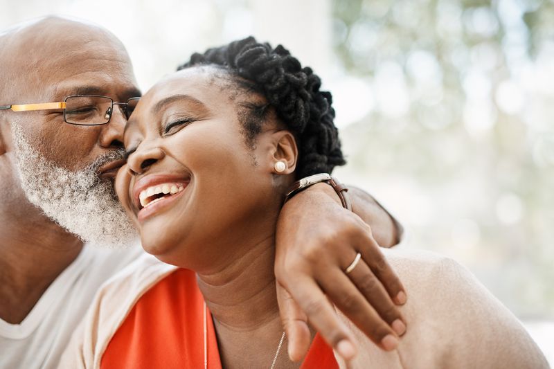Shot of a mature man affectionately kissing his wife at home