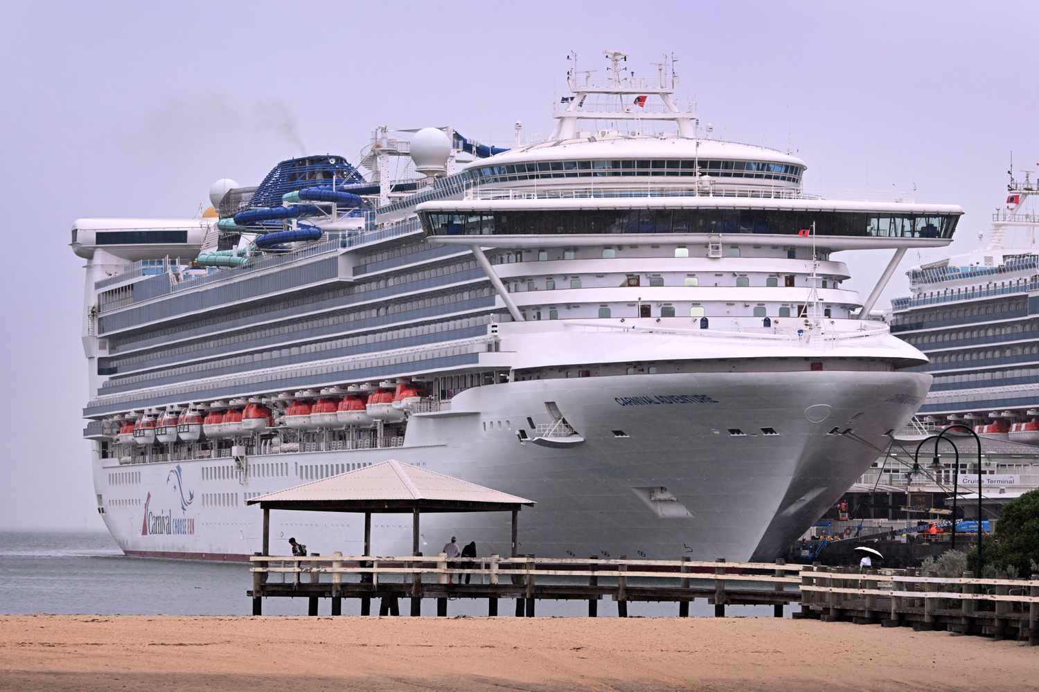 People look at the Carnival Adventure cruise ship moored at Melbourne's Station Pier on March 20, 2025