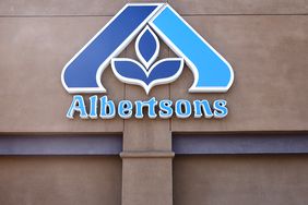 The blue Albertsons sign is seen on the side of a store.