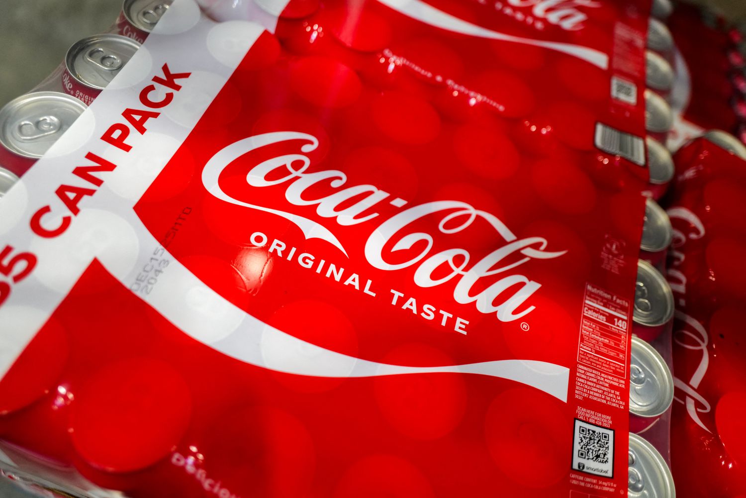 The Coca-Cola logo on the red packaging of a case of Coca-Cola