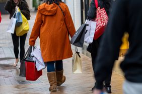 Shoppers carry bags at a mall in California. 