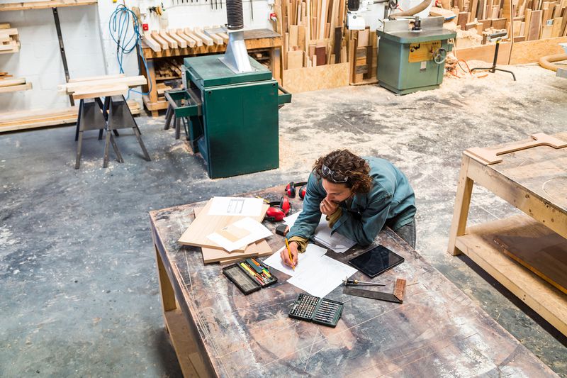 Designer Working at a Bench in a Furniture Factory