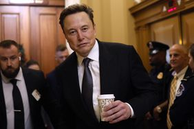 Elon Musk and other people are seen walking through the Capitol building in Washington, D.C.
