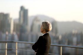 Female CEO standing on building rooftop