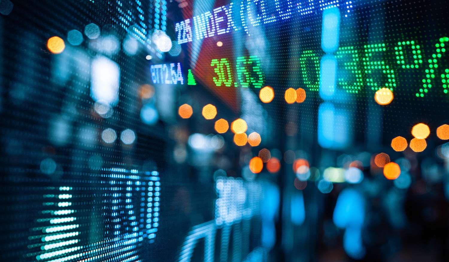 Display of Stock Market Quotes With City Scene Reflect on Glass