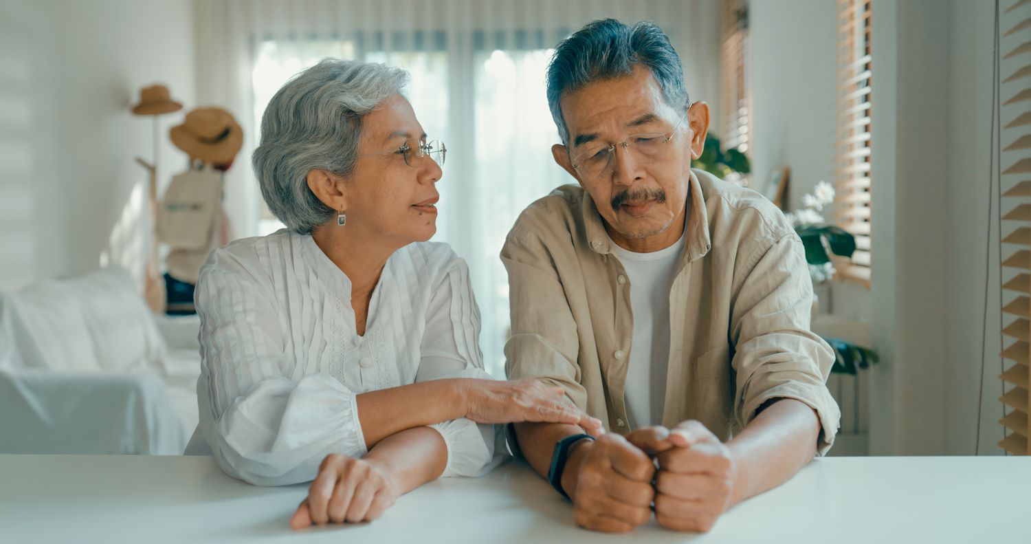 Older adult couple sitting down