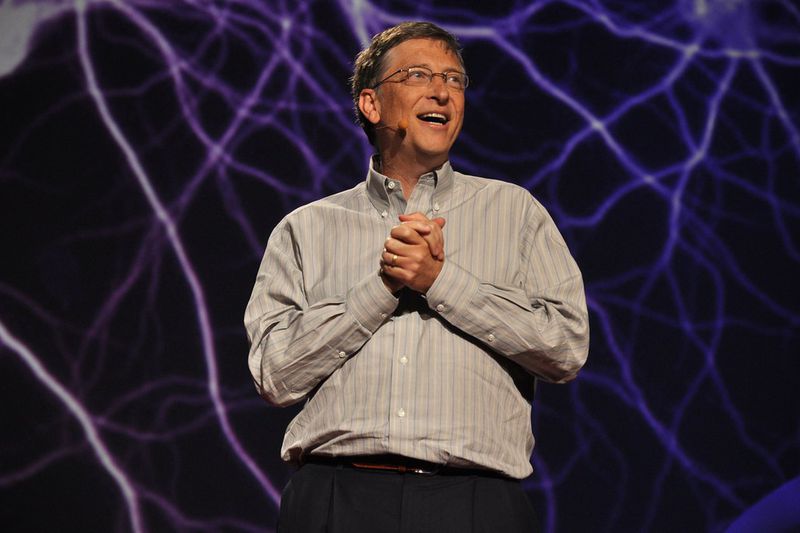 Bill Gates over a lightning background