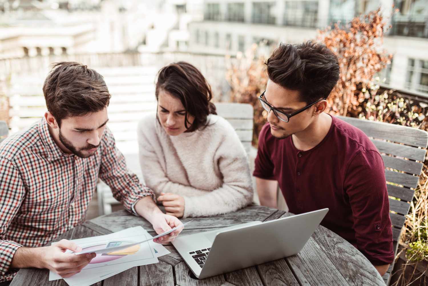 Three students study together.