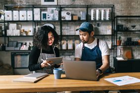 The owners of this coffee shop engage in a lively discussion, exchanging ideas and making plans for the business.