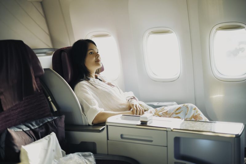 Person sitting in first class on an airplane