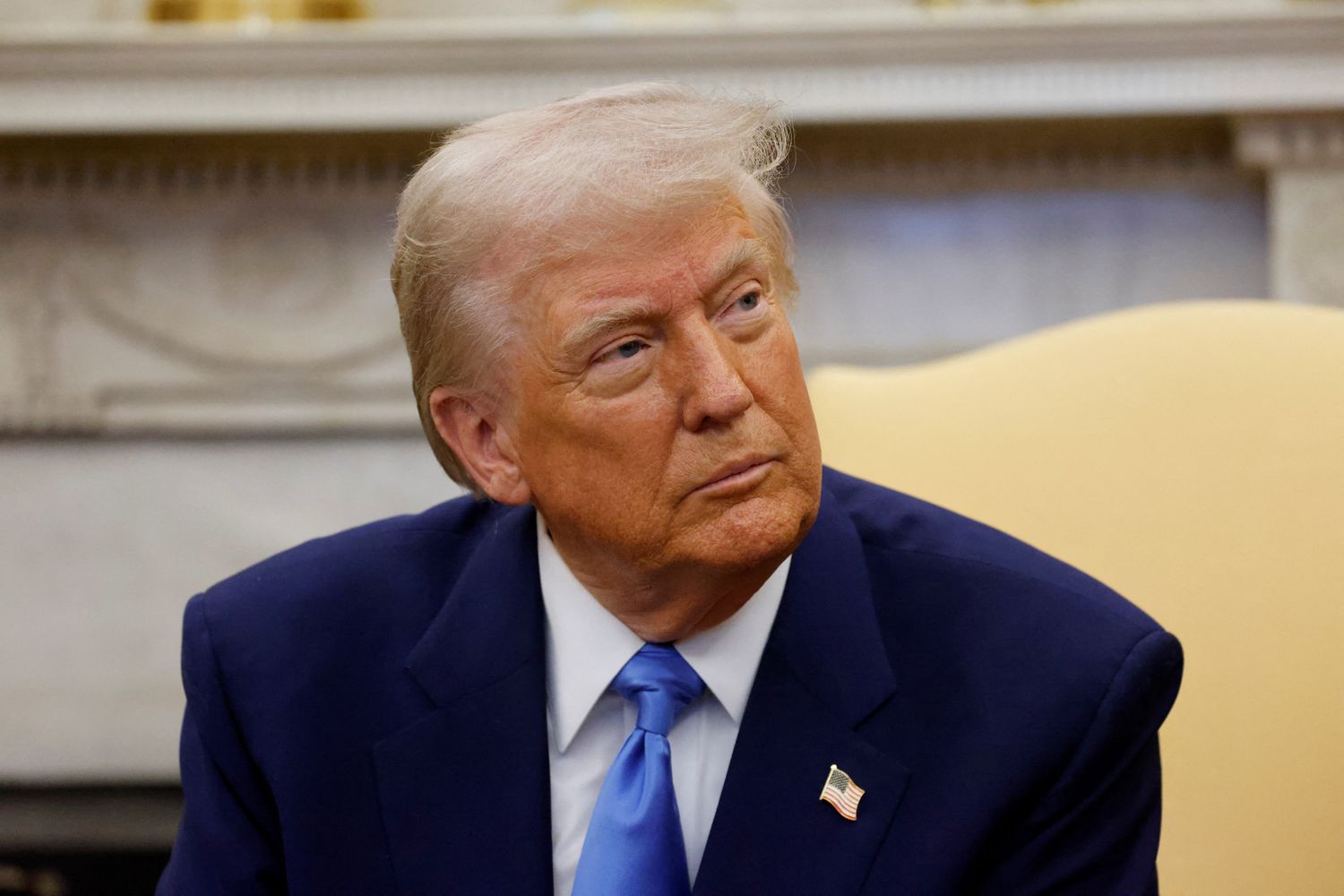 President Donald Trump looks to the left.