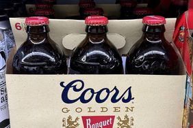 Bottles of Coors beer on a store shelf. 
