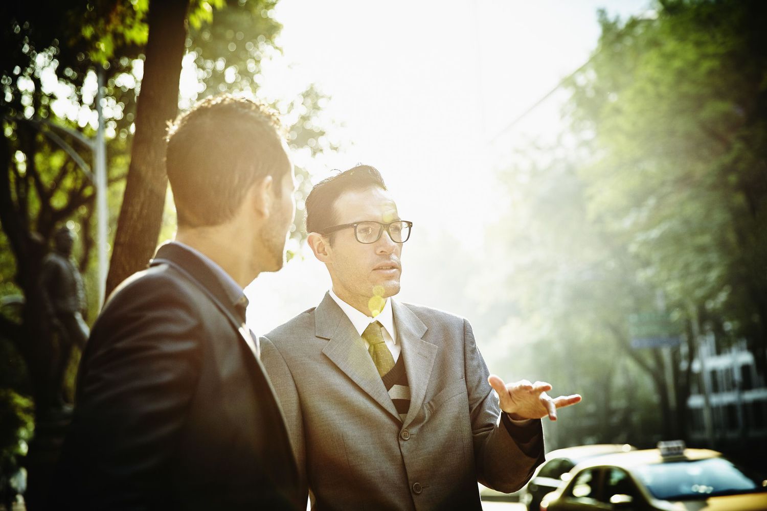 Two financial professionals talking outside
