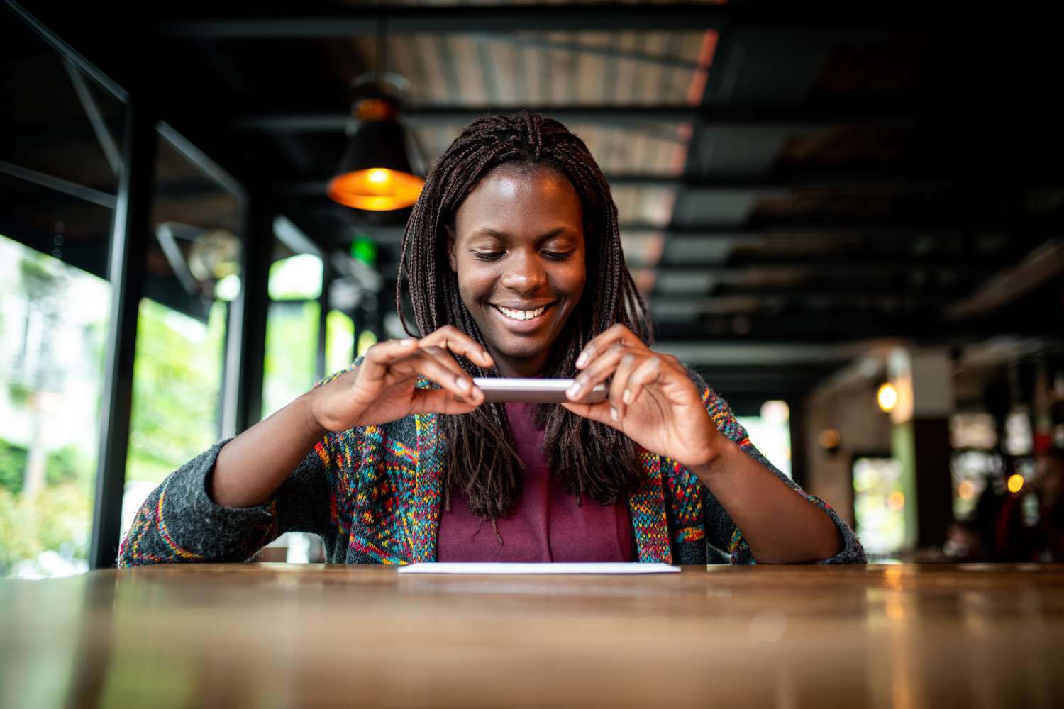 Young African woman making mobile deposit