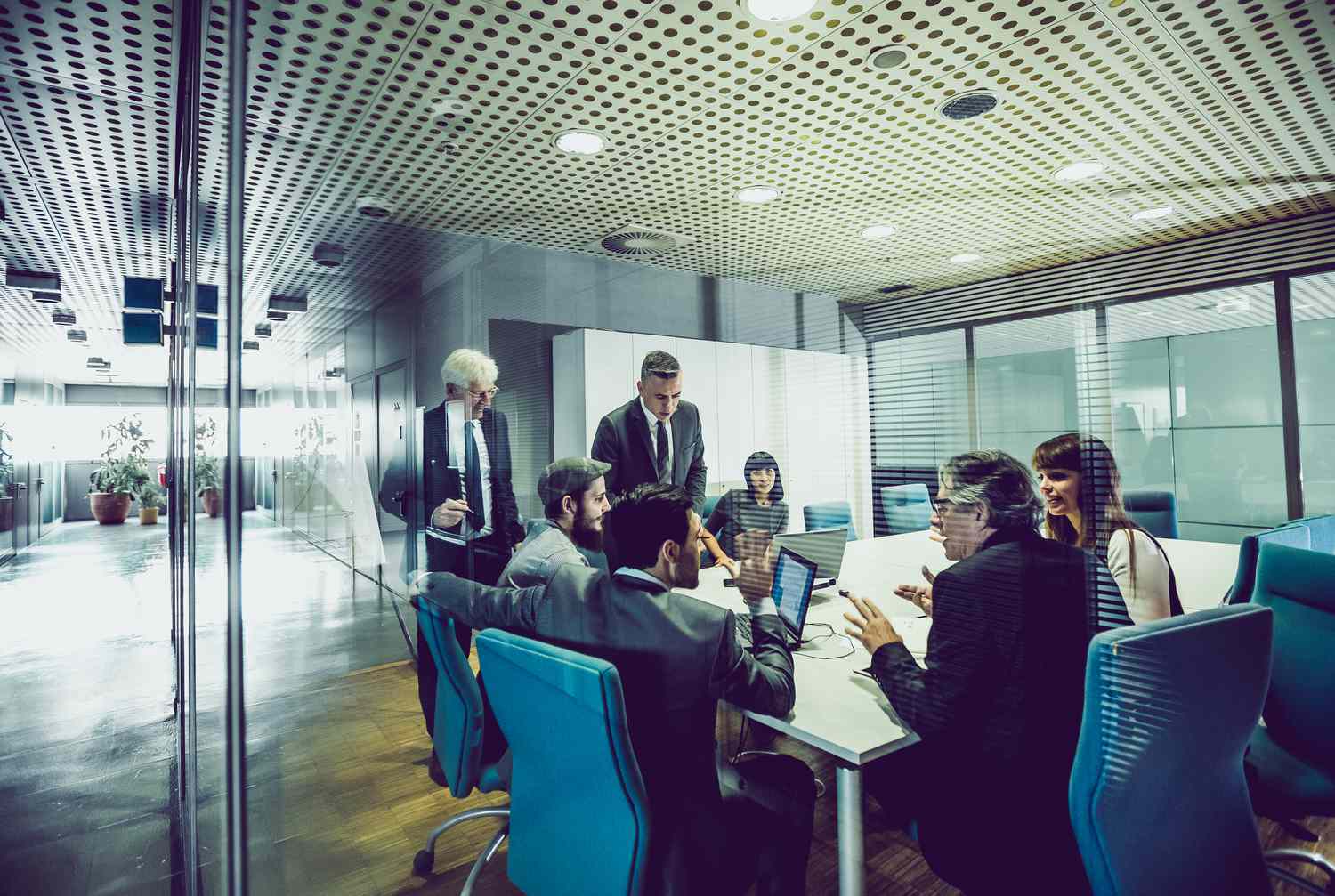 A group of business people having a meeting in an office and discussing a merger