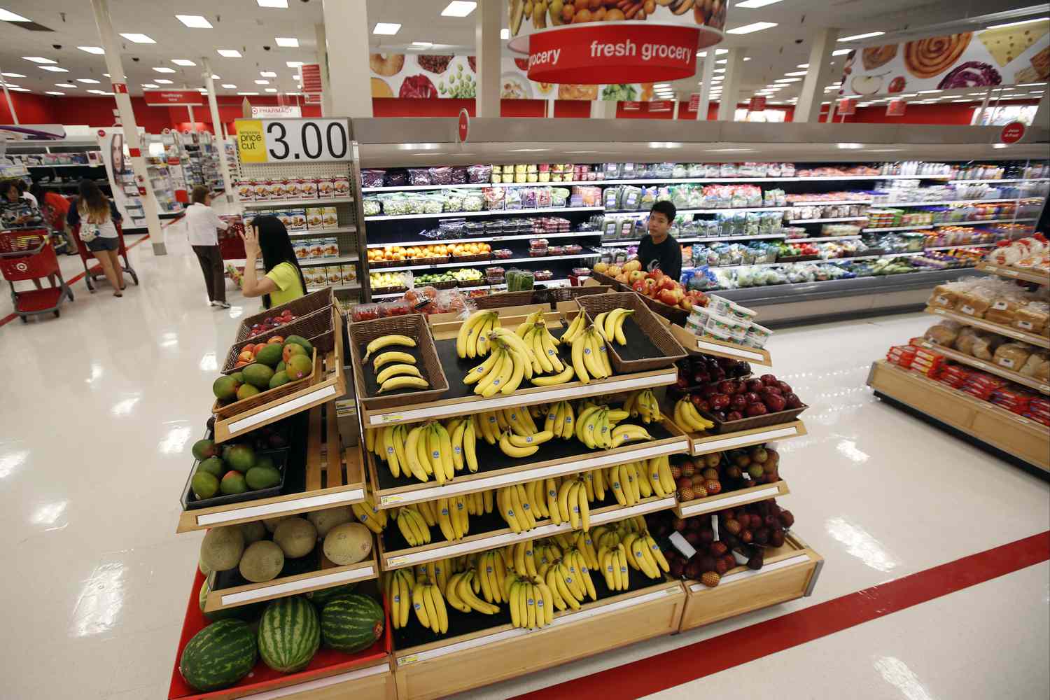 Shoppers walk through the produce section at Target. 