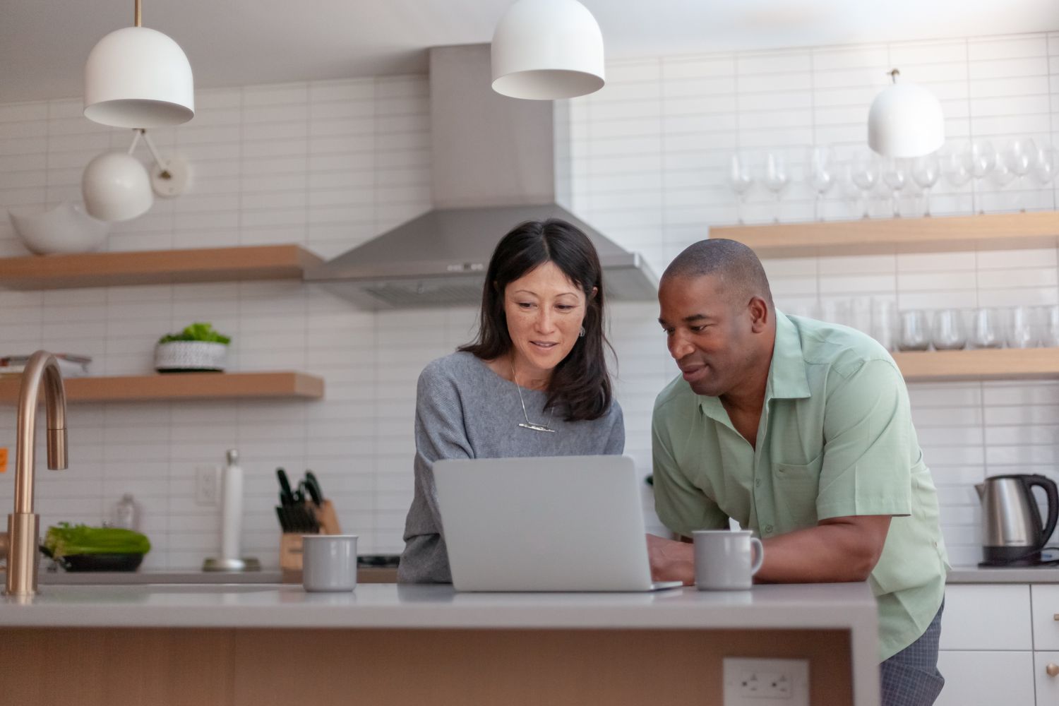 Couple in a kitchen with a computer