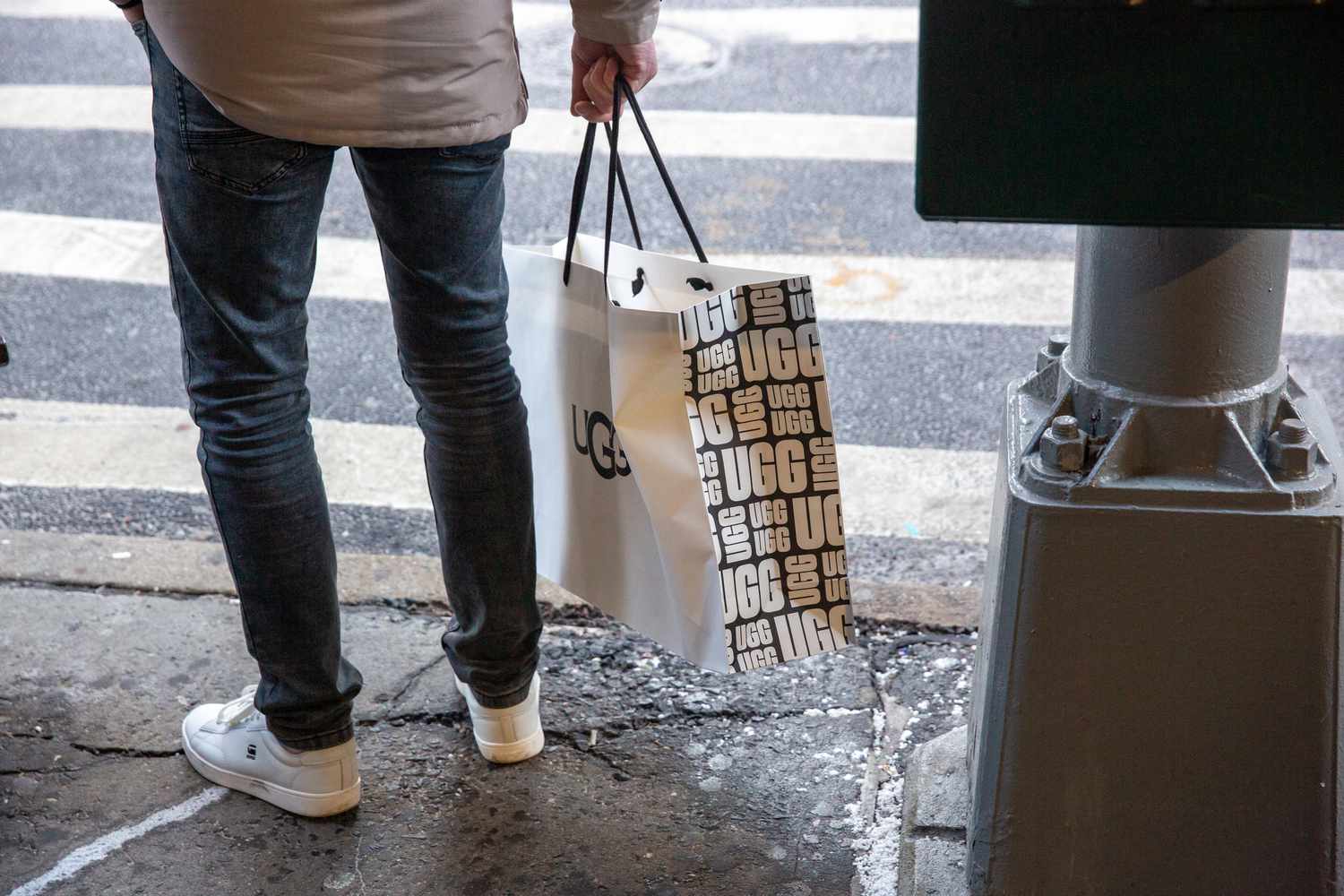A shopper carries an UGG bag.