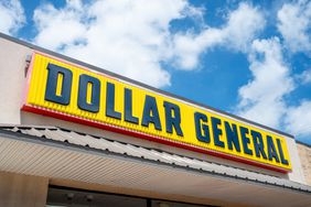 The black and yellow Dollar General logo is seen on a sign above the entrance to a building.