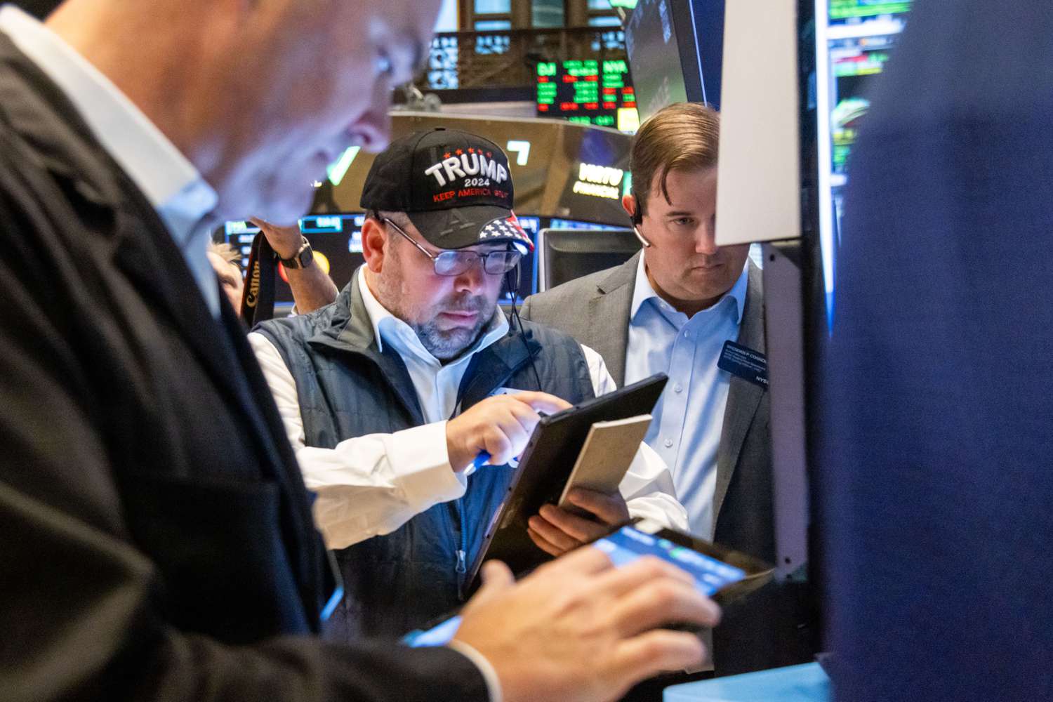 A trader wearing a Trump hat works on the floor of the New York Stock Exchange (NYSE) in New York, US, on Wednesday, Nov. 6, 2024.