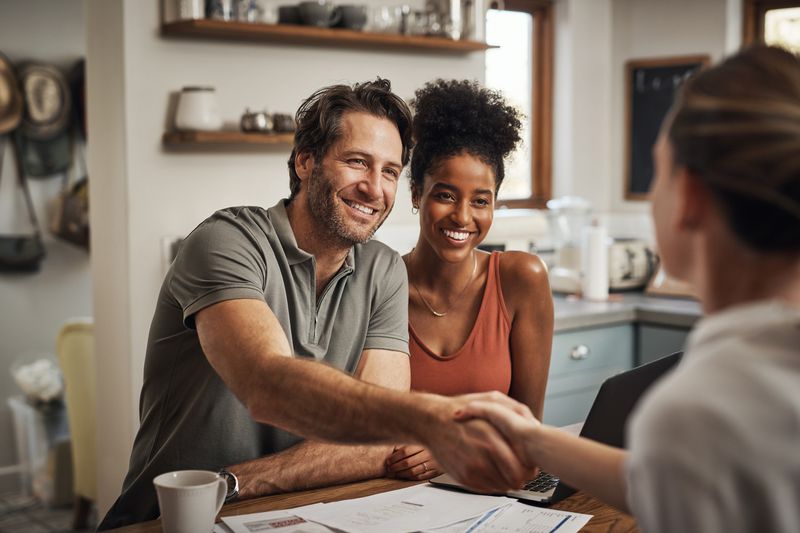 A couple finishes signing paperwork for a home equity loan