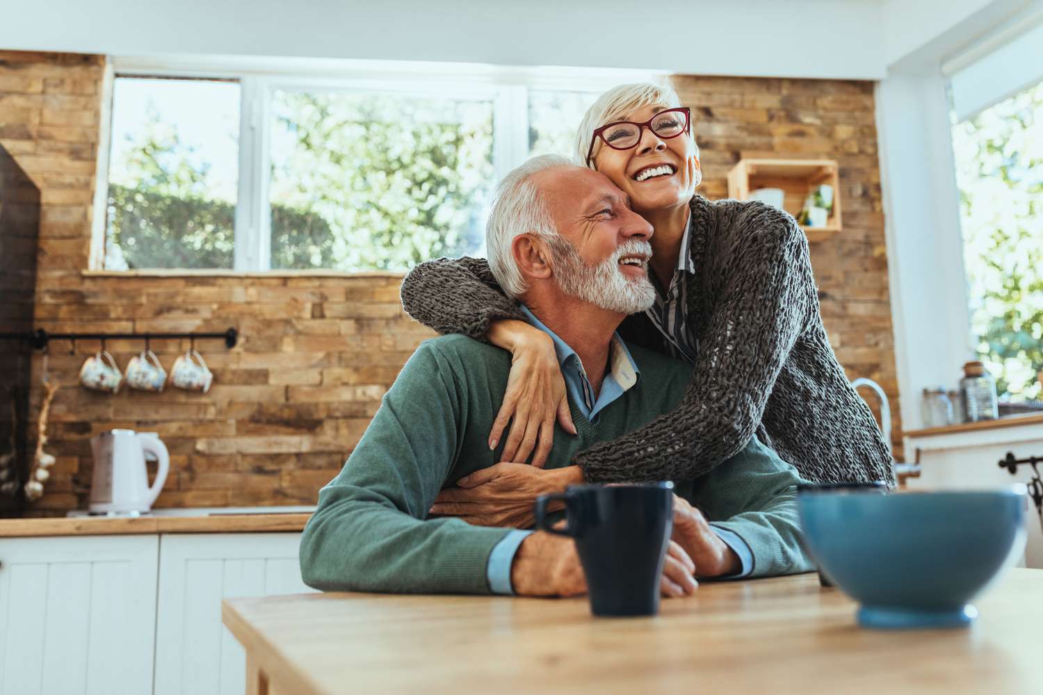 Elderly couple hugging in the kitchen