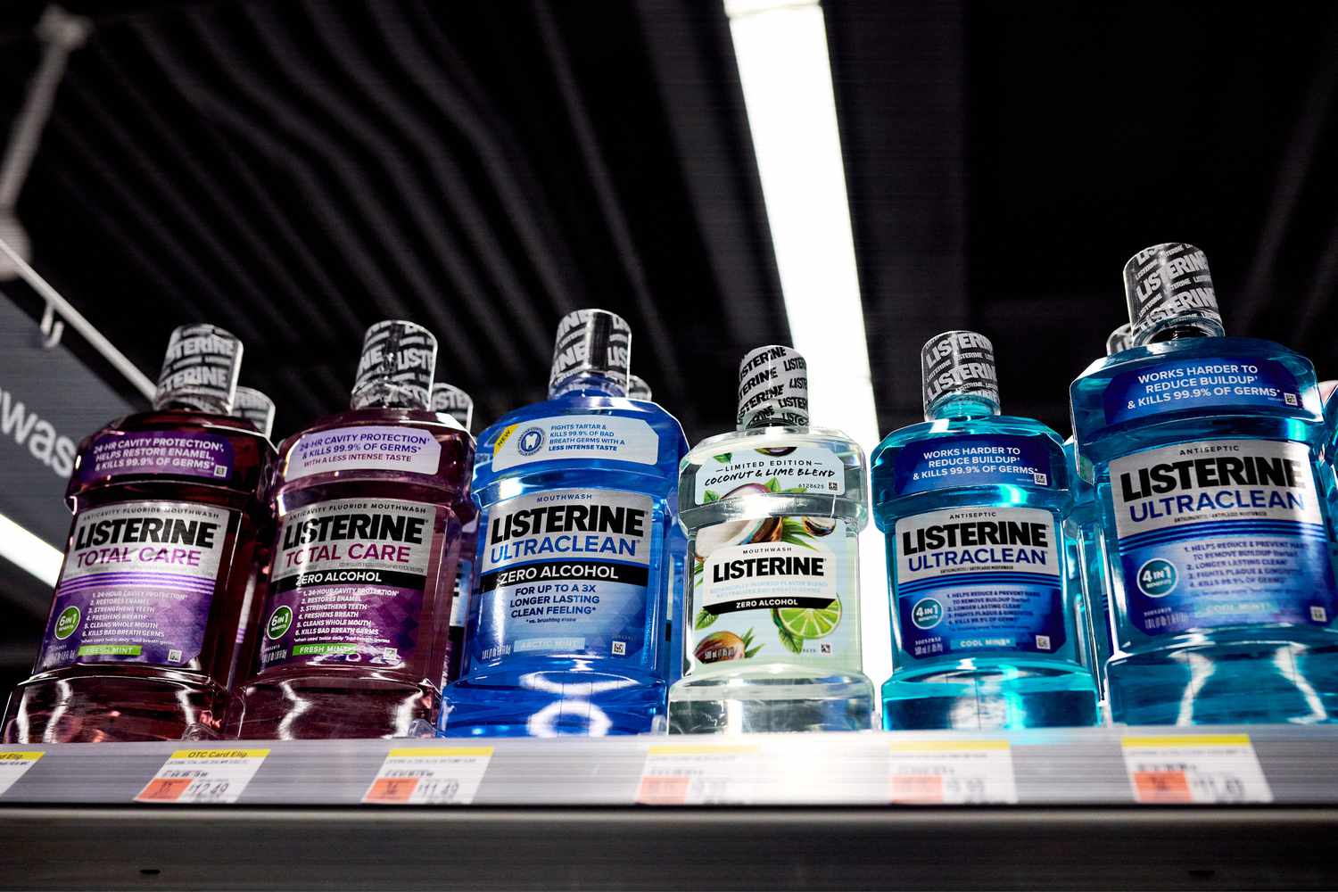 Bottles of Listerine mouthwash sit on a shelf.