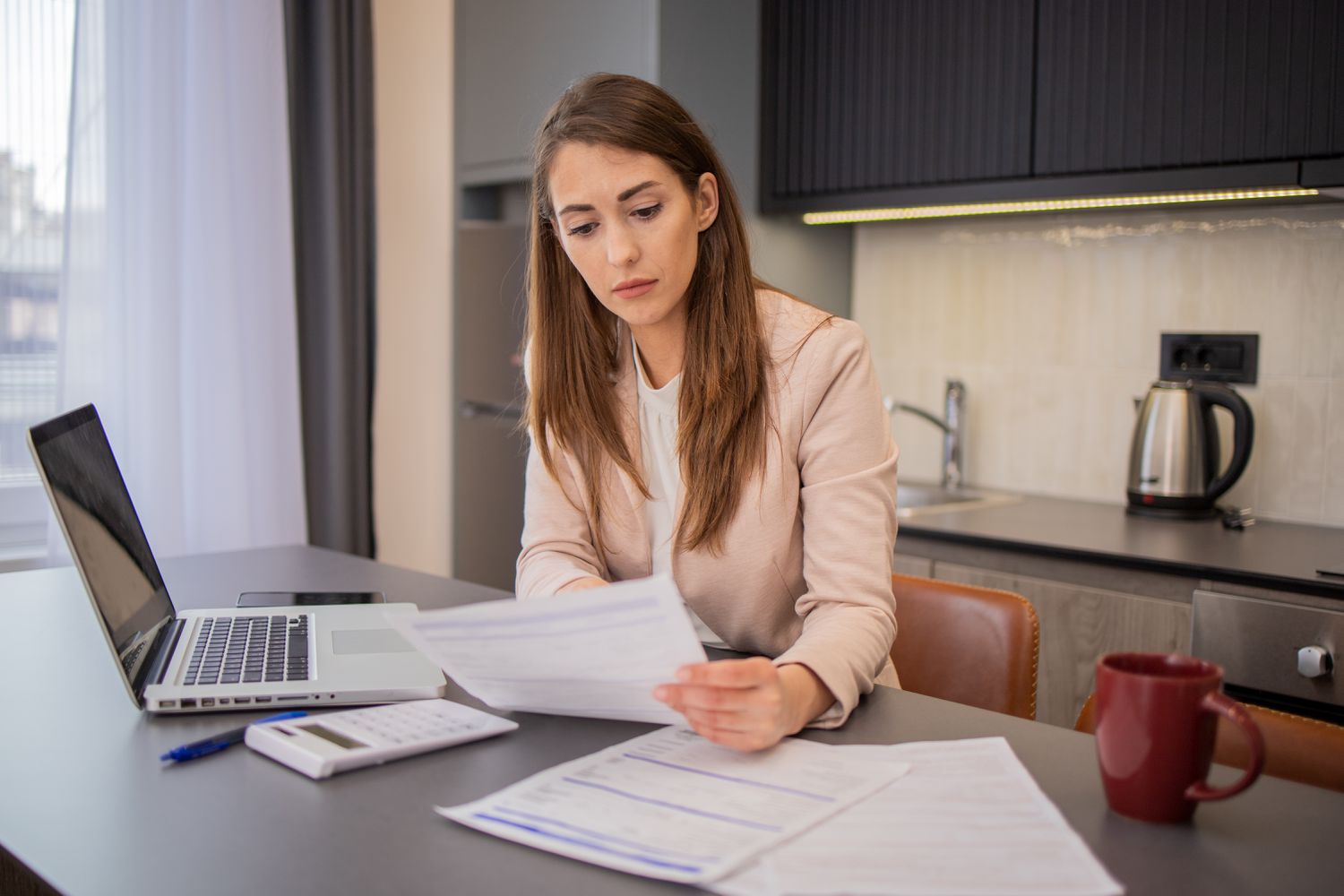 A woman with papers and a computer