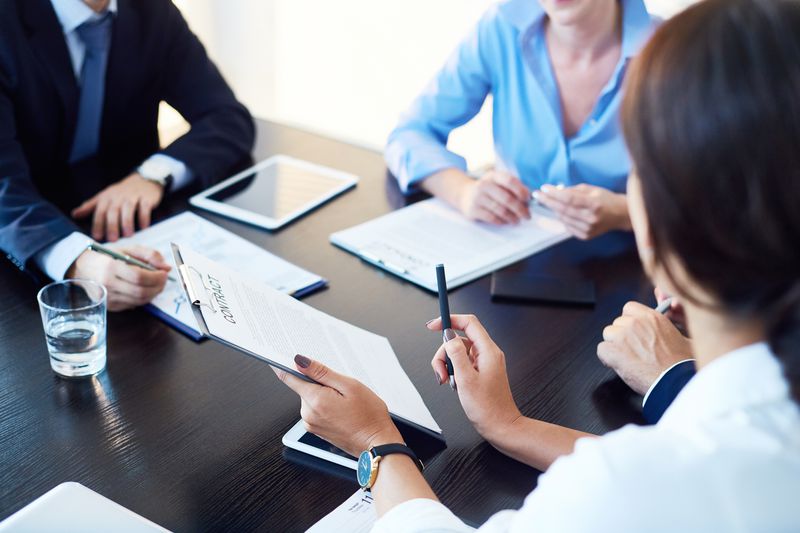 Three people going over a contract