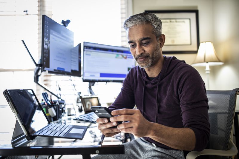 Stock trader checks prices on a mobile phone