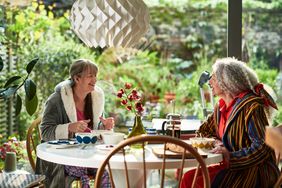 Two women chat over breakfast on the patio