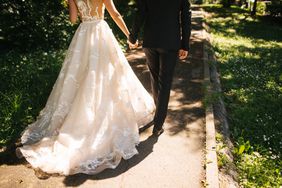 Bride and groom walking on pavements.