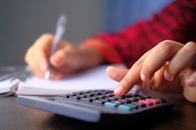 Woman's Hands Counts on the Calculator