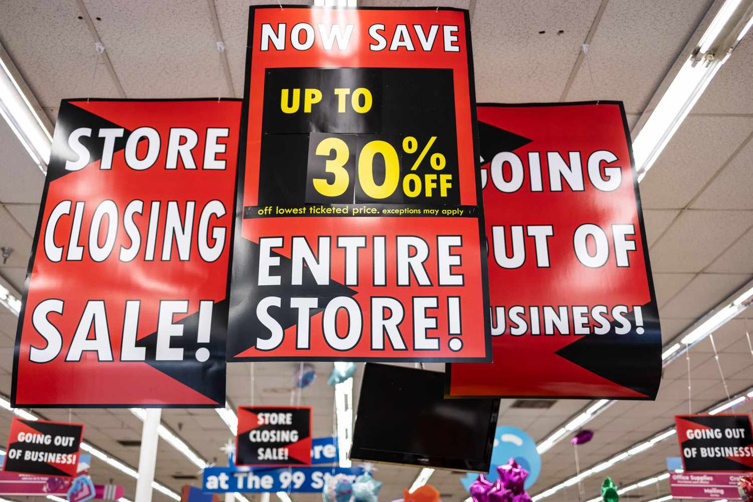 Signs hanging from the ceiling read, "Store Closing Sale," "Now Save Up To 30% off Entire Store," and "Going Out Of Business," inside a 99 Cents Only Store, April 16, 2024, in Torrance, California