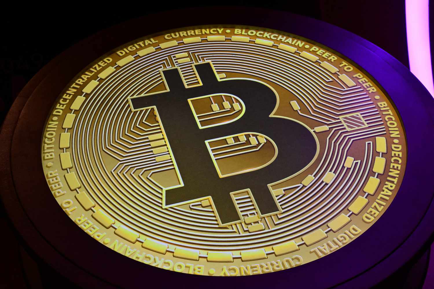The Bitcoin symbol is displayed at a conference.