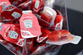 a close-up of packets of Kraft Heinz ketchup. 