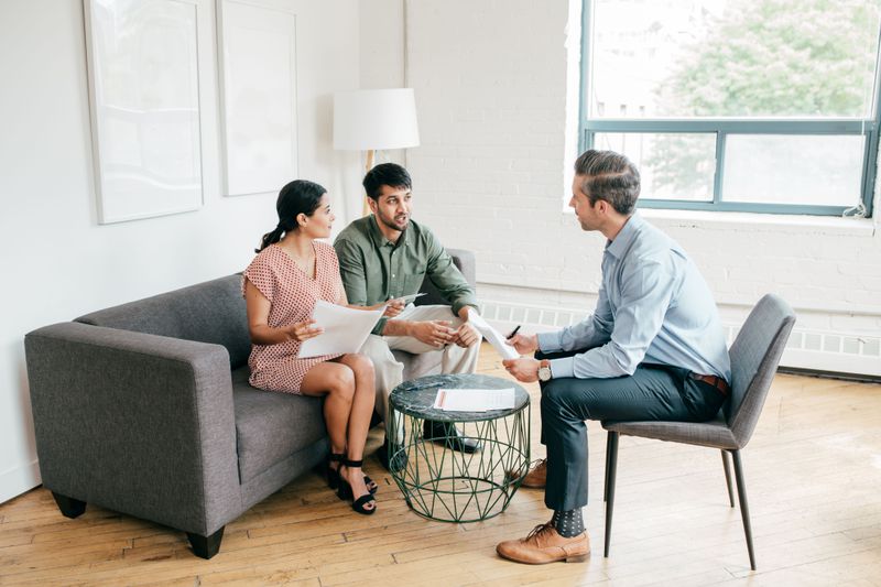 Three people in a meeting in an office