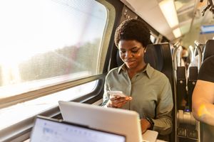 A woman on the train multi-tasking.